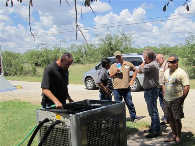 Responders setting up field equipment on a lawn during regional training